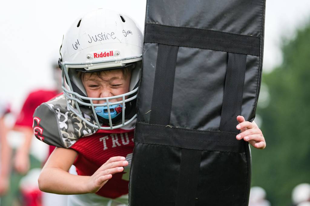 A youth player practices tackling.